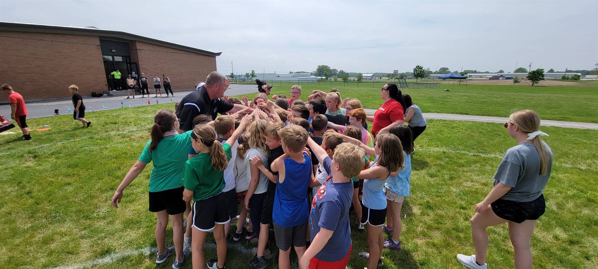 Mr. Ahrens teaching about teamwork and respect during the kickball tournament.