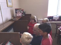 Mrs. Klosterman trains students on using the card catalog online to locate books.